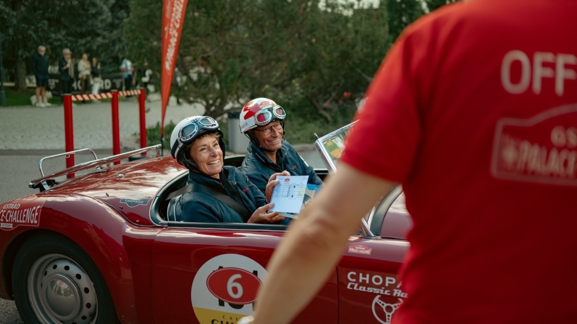 The team in a red classic hands in their time card at the Gstaad Palace Challenge finish line