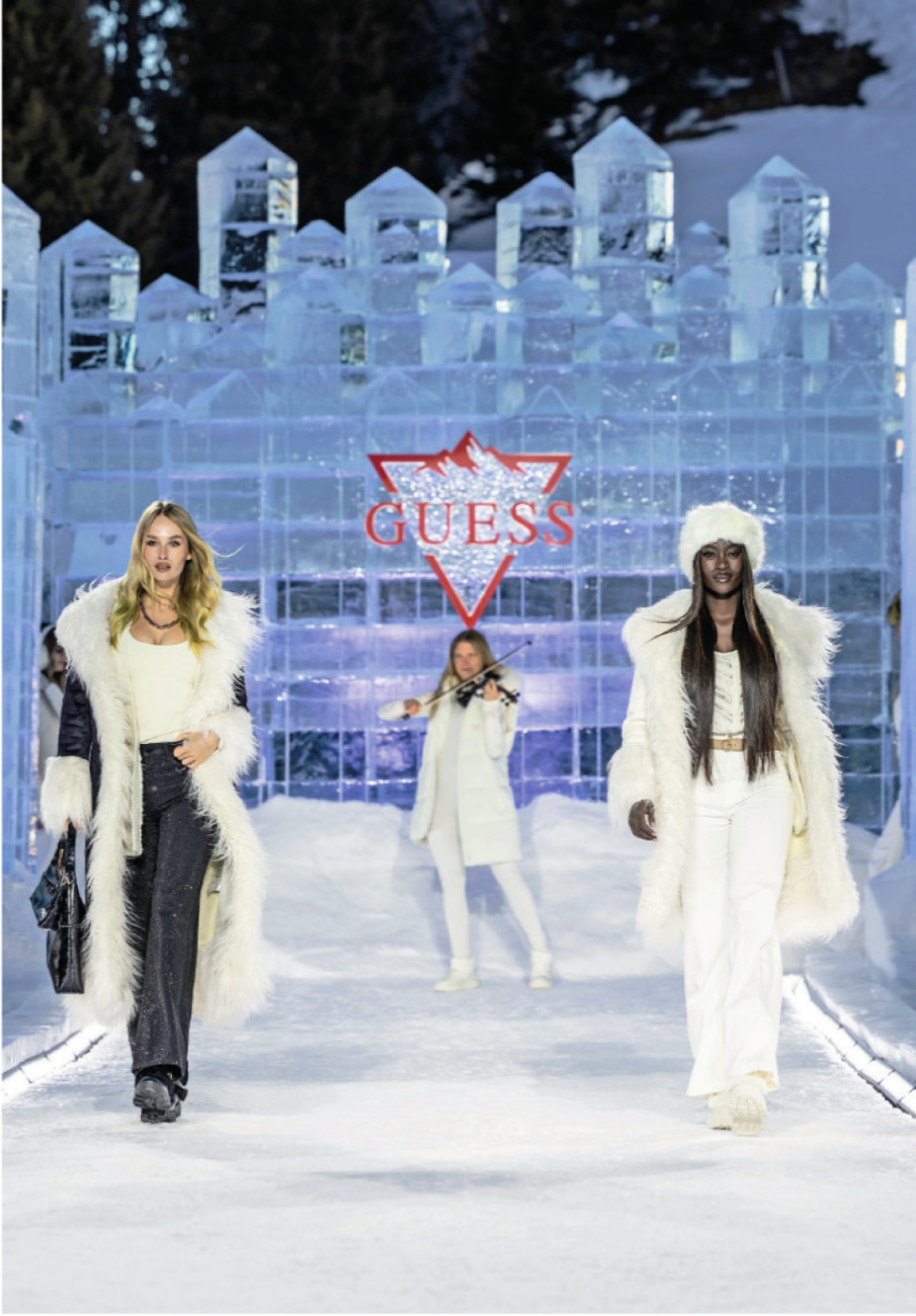 A catwalk made entirely of ice. Models emerged from transparent, crystalline structures reminiscent of minerals and quartz formations. The show was framed by a live performance from electric violinist Laura Zimmermann (centre). PHOTO: GUESS